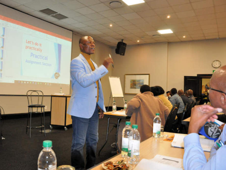 Workshop attendees taking notes at a Mhangwana training session